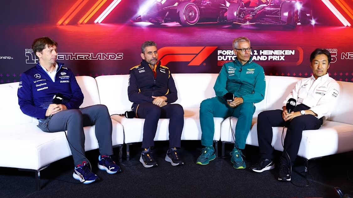 Formula 1 Team Principals sit on white sofa during a press conference